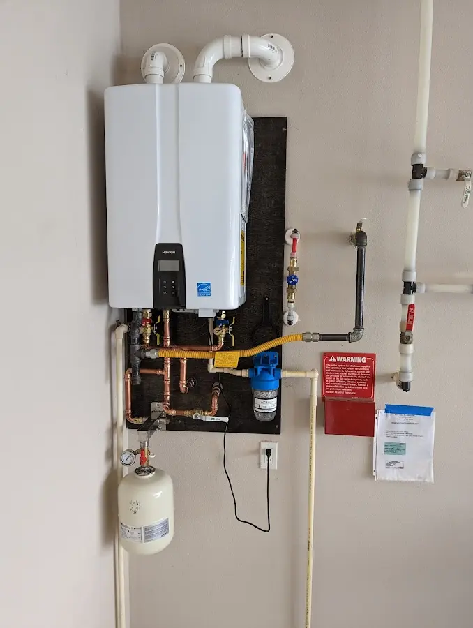 Professional plumber installing copper piping in a Plano home